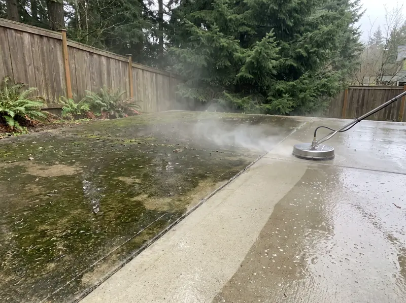 Mossy concrete patio being pressure washed clean in Oregon