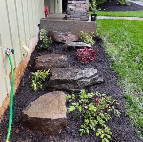 Rock and planting bed built along a house in Salem